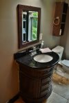 A custom curved antique sink and mirror.  